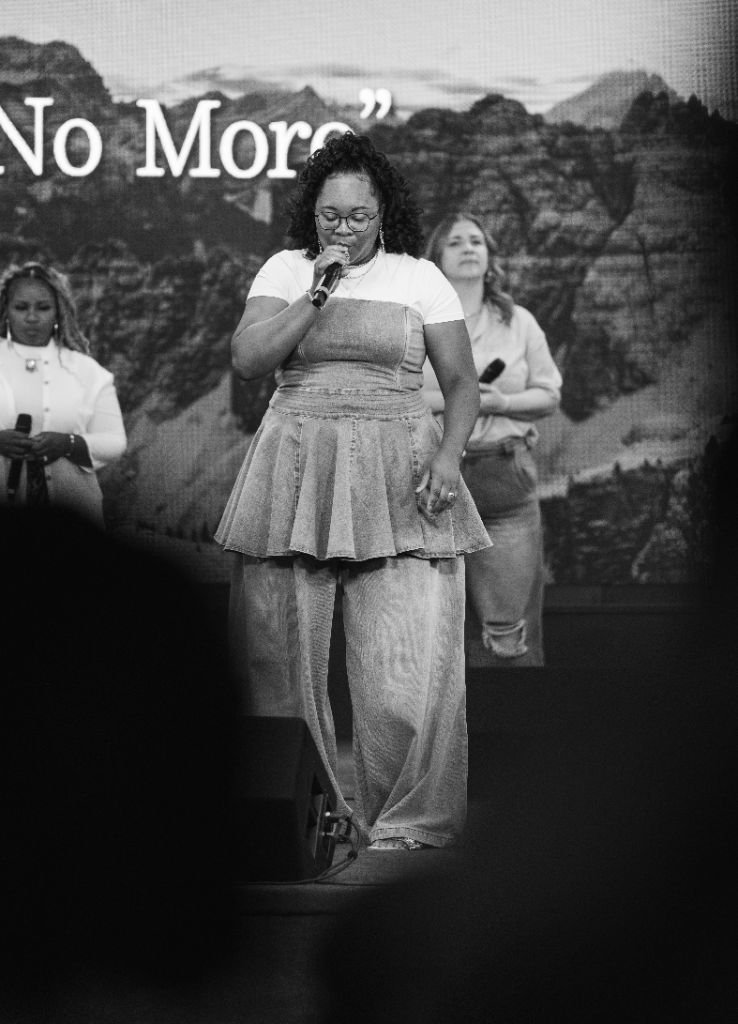 Donielle Houston singing on stage at a live worship night